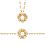 Gold plated necklace and bracelet set on a white background