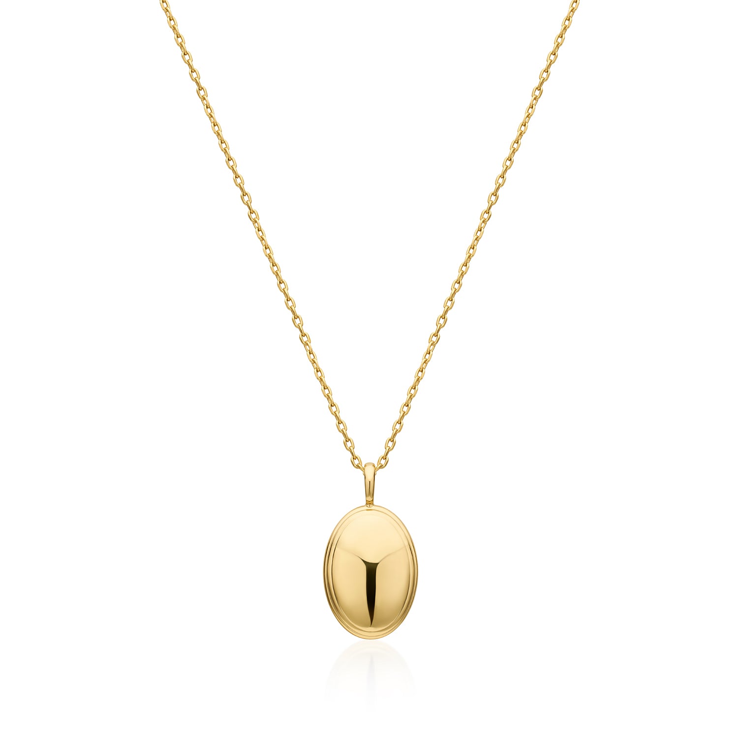 A gold oval locket pendant necklace on a delicate gold chain, presented against a clean white background with a soft reflection below.