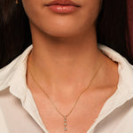 A close-up of a model wearing Classic Cuteness Necklace in 18K Gold Plating with Round, Marquise and Pear Cut Cubic Zirconia Drop Pendant | Burren Jewellery