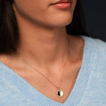 Model wearing Glamorous Goddess Necklace in 18K Gold Plating with Engravable Circular Disc Pendant Surrounded by Cubic Zirconia | Burren Jewellery