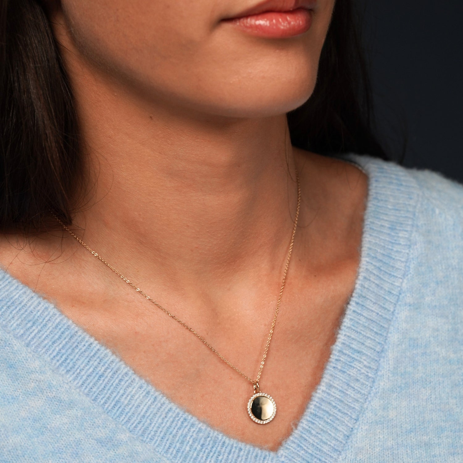 Model wearing Glamorous Goddess Necklace in 18K Gold Plating with Engravable Circular Disc Pendant Surrounded by Cubic Zirconia | Burren Jewellery