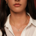 A close-up of a model wearing Flower Garden Pendant Necklace in 18K Gold Plating Featuring a Floral Cubic Zirconia Pendant | Burren Jewellery