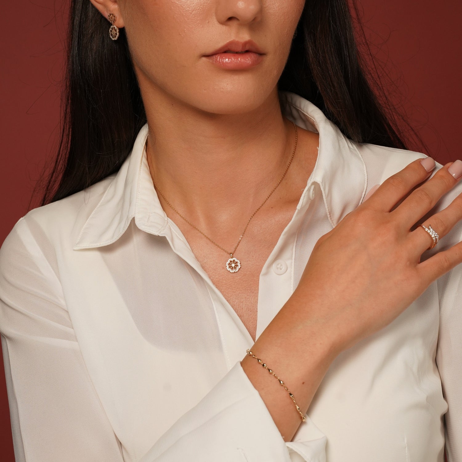 A close-up lifestyle shot of a model wearing Flower Garden Earrings in 18K Gold Plating Featuring Floral Drop Earrings with Cubic Zirconia | Burren Jewellery