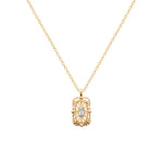 A gold necklace with a rectangular filigree pendant featuring a central clear baguette gemstone, displayed on a clean white background.