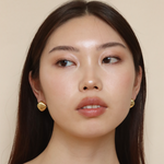 Burren jewellery 18k gold plated Stressed Perfection button dome earring on model