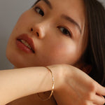 Burren jewellery 18k gold plated stop this train bangle on model