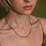 A close-up of a model wearing Golden Apology 18K Gold Plated Textured Link Chain Necklace | Burren Jewellery
