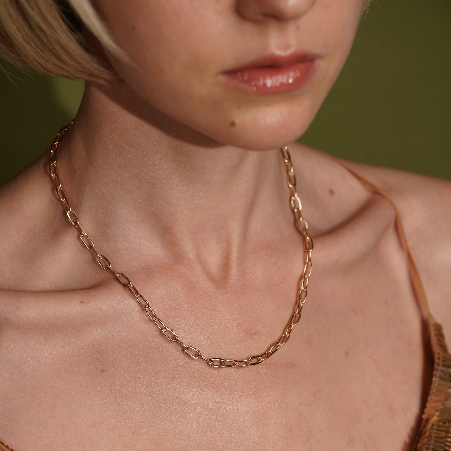 A close-up of a model wearing Golden Apology 18K Gold Plated Textured Link Chain Necklace | Burren Jewellery
