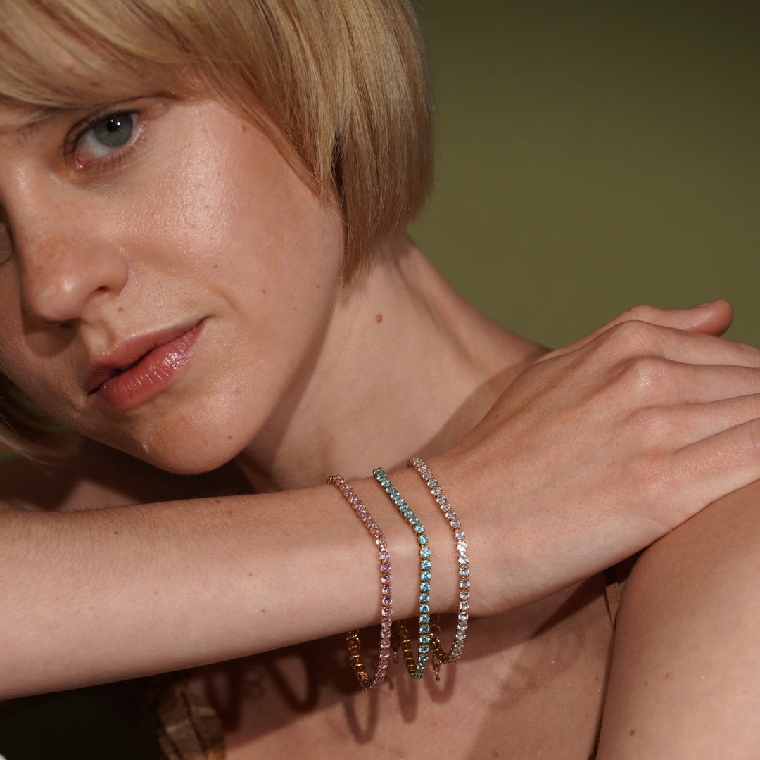 A lifestyle shot of a model wearing three delicate 18K Gold Plated Tennis Bracelet with Cubic Zirconia | Burren Jewellery
