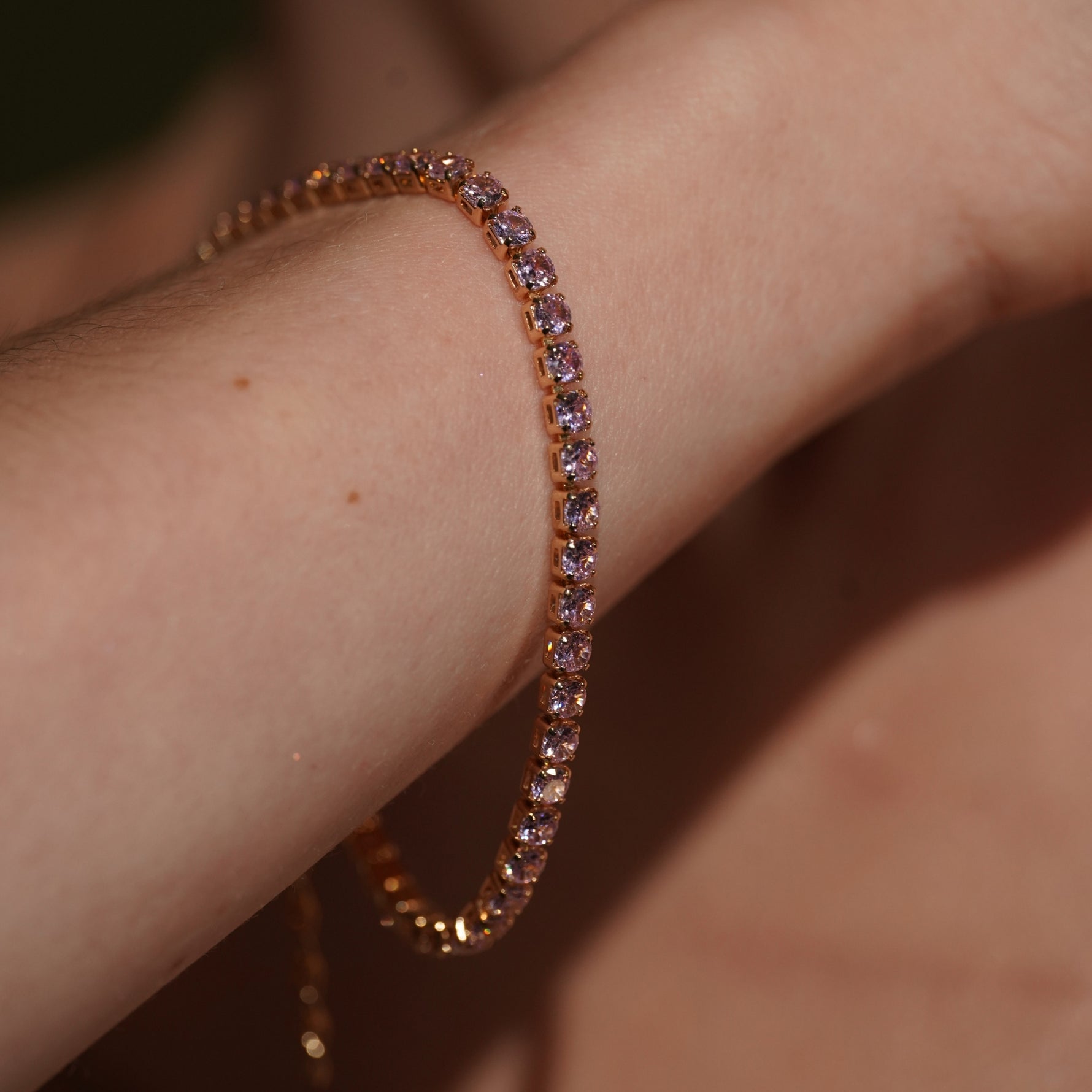 A close-up of Cool Cat 18K Gold Plated Tennis Bracelet with Pink Cubic Zirconia | Burren Jewellery
