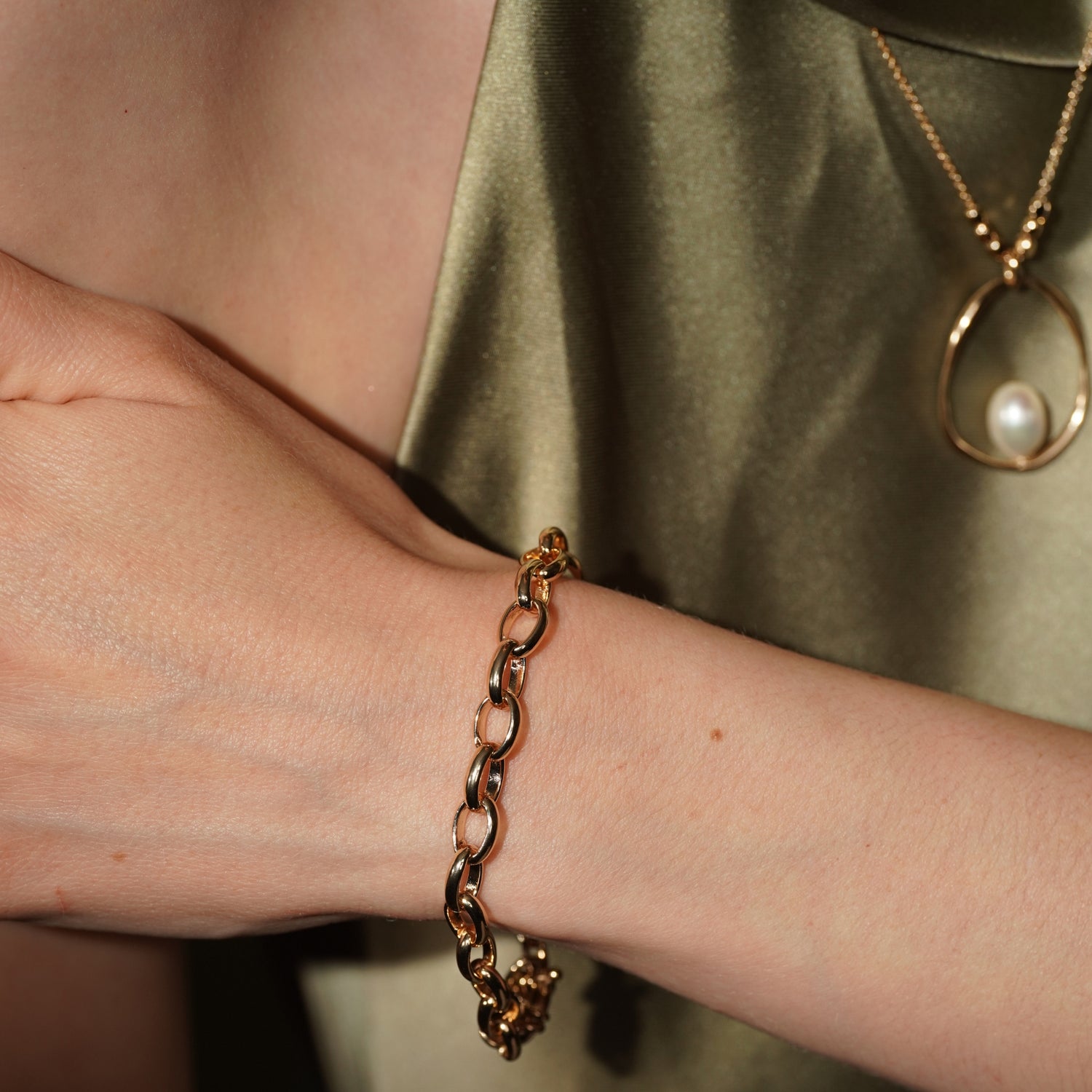 A close-up of a person's wrist wearing Dirty Jazz 18K Gold Plated Classic Oval Link Chain Bracelet | Burren Jewellery