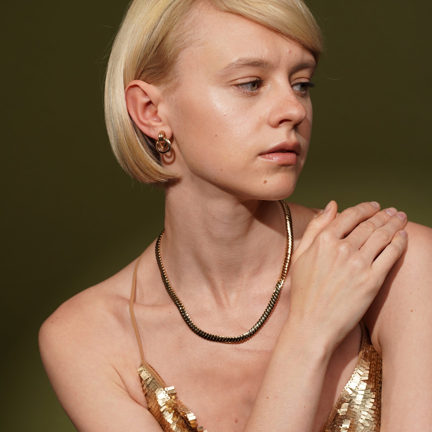 Model wearing Dove Earrings in 18K Gold Plating Featuring a Sculptural Triple Interlocking Hoop Stud Design | Burren Jewellery