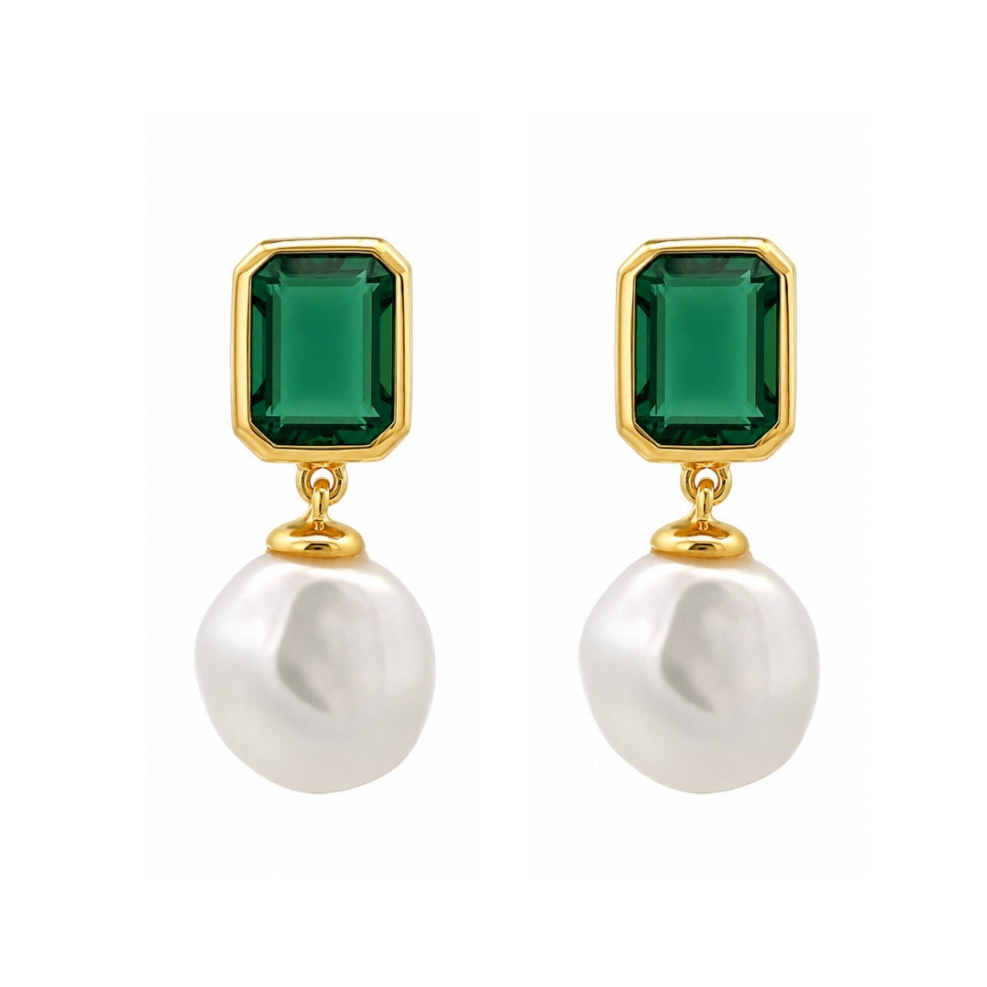 A pair of gold drop earrings featuring rectangular emerald-cut green gemstones and dangling baroque white pearls, set against a plain white background.
