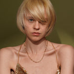 A close-up portrait of a model with Golden Apology 18K Gold Plated Textured Link Chain Necklace | Burren Jewellery
