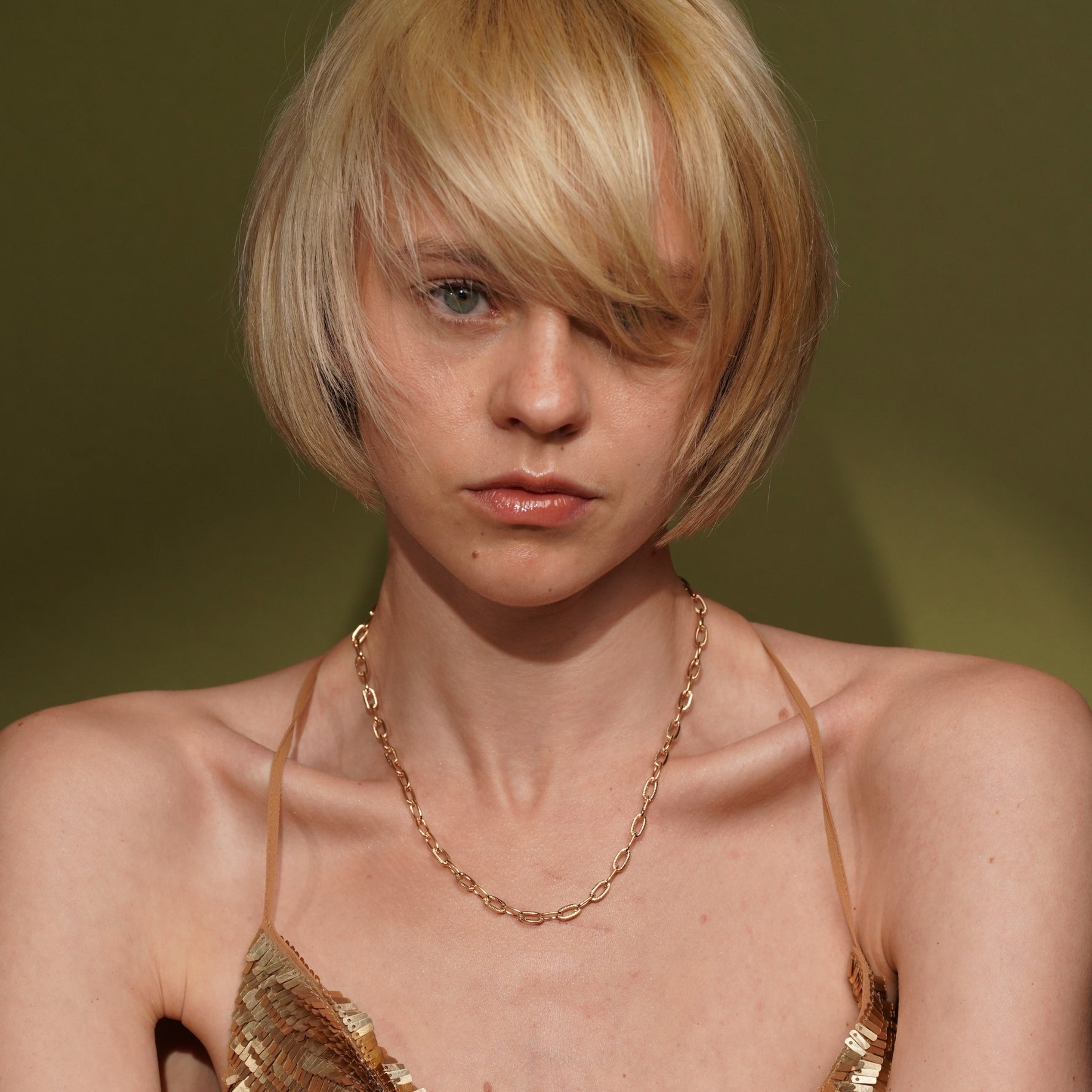 A close-up portrait of a model with Golden Apology 18K Gold Plated Textured Link Chain Necklace | Burren Jewellery
