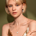 Model wearing Ocean Drop Earrings in 18K Gold Plating Featuring Genuine Freshwater Pearl Drop Huggie Earrings | Burren Jewellery
