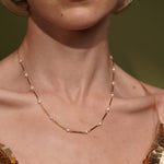A close-up of a model's neck wearing Never Say Goodbye 18K Gold Plated Freshwater Pearl Necklace | Burren Jewellery