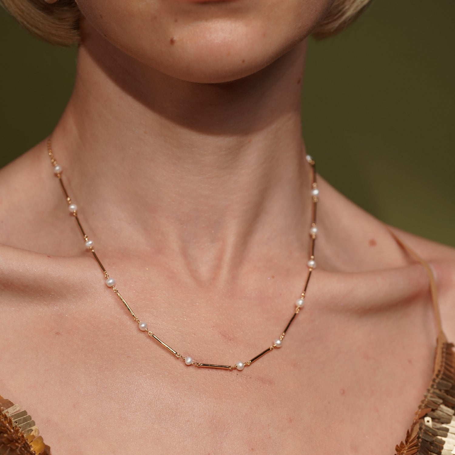 A close-up of a model's neck wearing Never Say Goodbye 18K Gold Plated Freshwater Pearl Necklace | Burren Jewellery