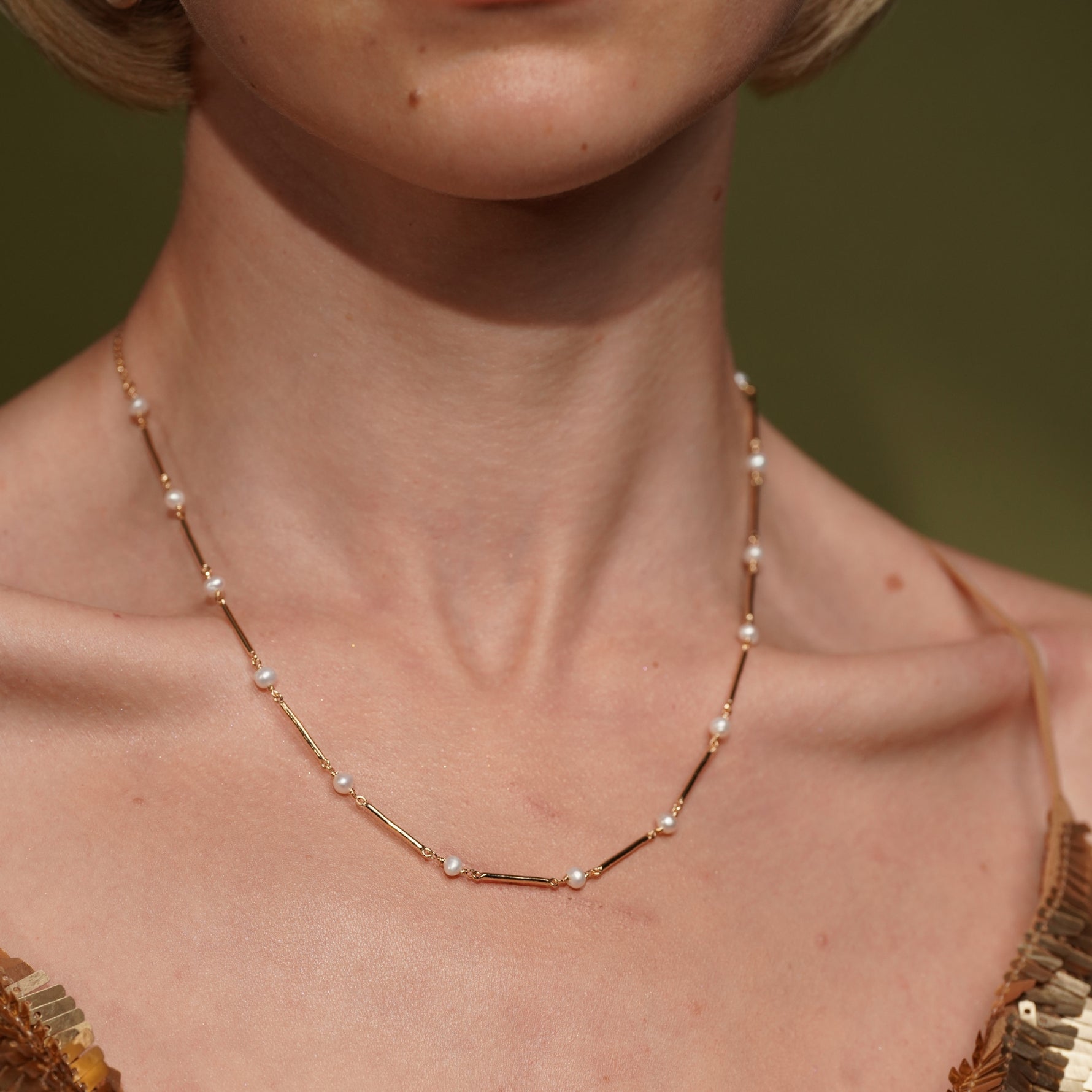 A close-up of a model's neck wearing Never Say Goodbye 18K Gold Plated Freshwater Pearl Necklace | Burren Jewellery