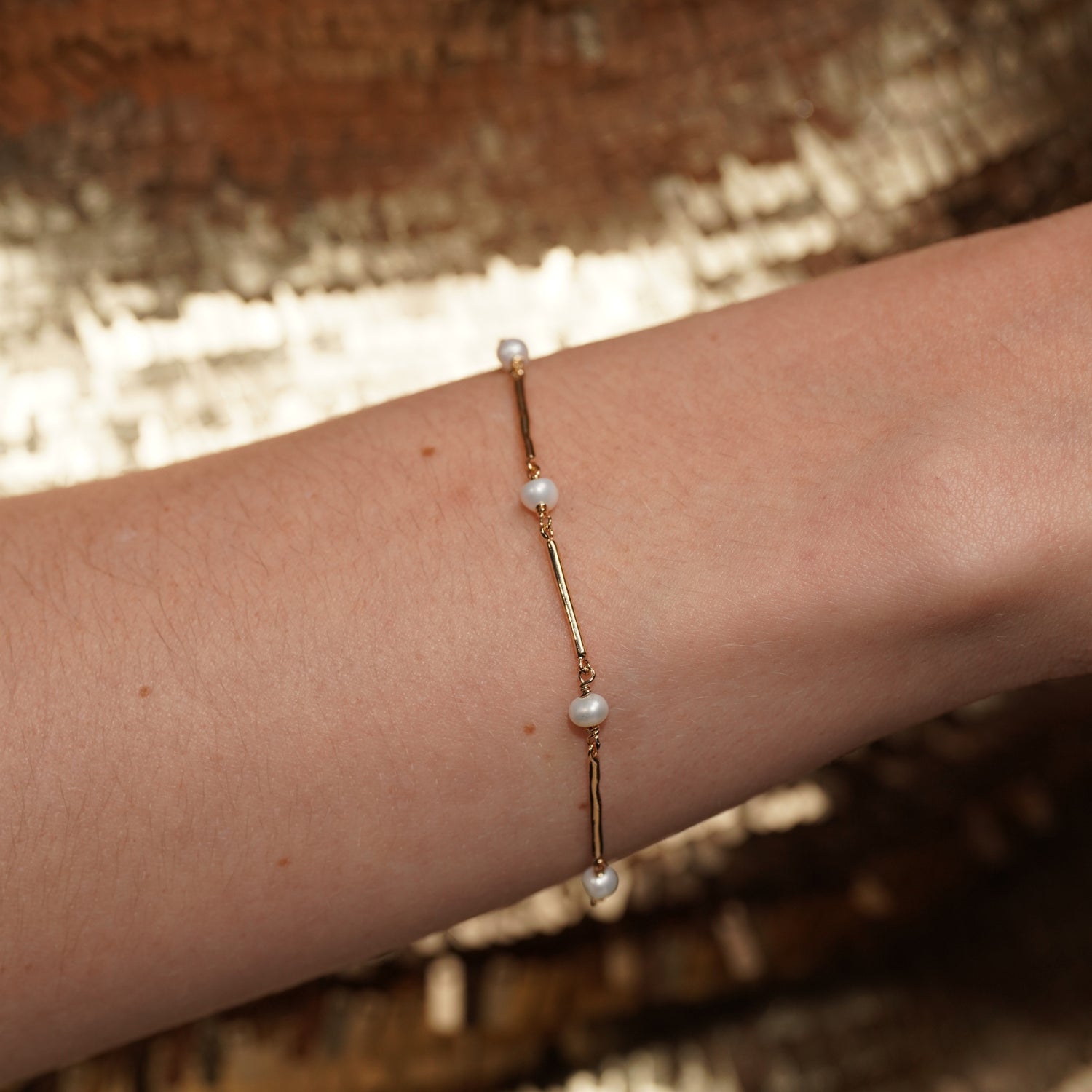 Closeup of models wrist wearing Never Say Goodbye 18K Gold Plated Freshwater Pearl Bracelet | Burren Jewellery