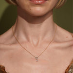 Model wearing the Arctic Edge gold plated pavé necklace resting at the collarbone