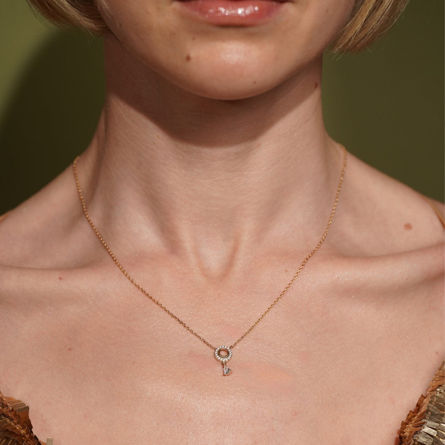Model wearing the Arctic Edge gold plated pavé necklace resting at the collarbone
