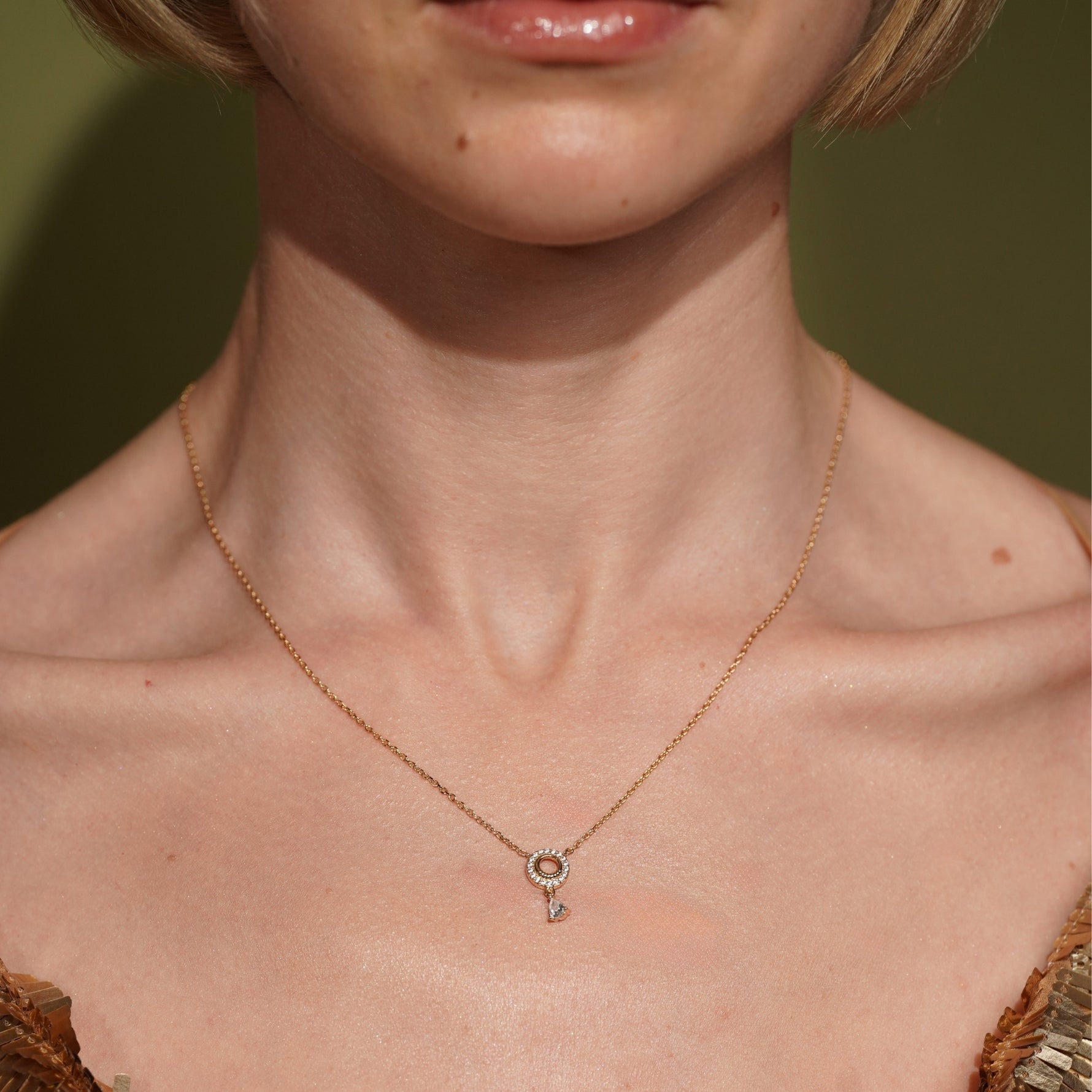 Model wearing the Arctic Edge gold plated pavé necklace resting at the collarbone