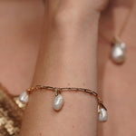 Model wearing the Sea Satin gold plated pearl bracelet, close up on the wrist