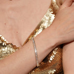 A close-up of a person's wrist wearing Pure Soul 18K Gold Plated Baguette Cubic Zirconia Tennis Bracelet | Burren Jewellery
