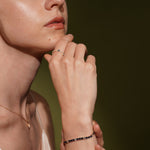 Close-up of a model wearing a delicate gold ring and No Apologies 18K Gold Plated Tennis Bracelet with Sapphire Blue and Clear Cubic Zirconia | Burren Jewellery