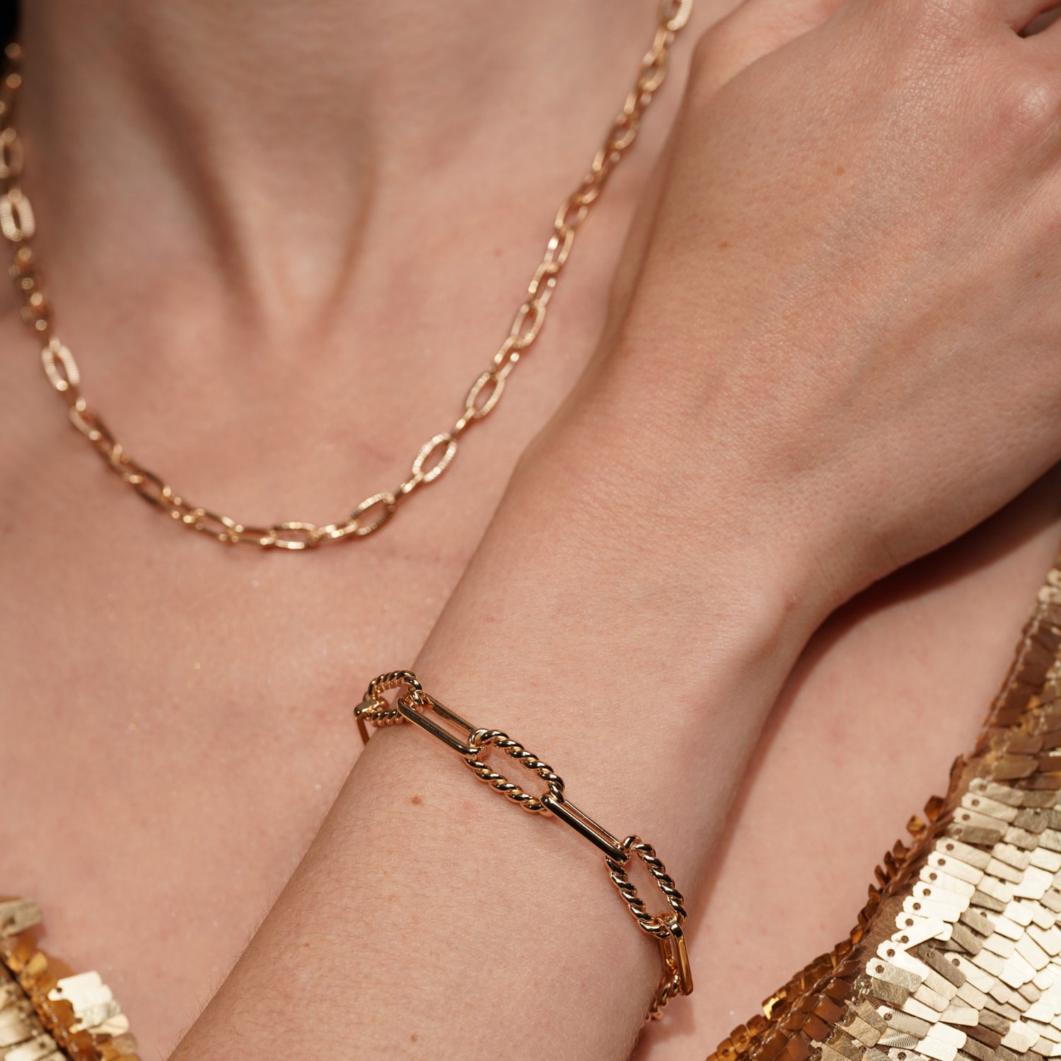 A close-up lifestyle shot of a model's wrist wearing Old Record 18K Gold Plated Mixed Link Chain Bracelet with Twisted Rope Detailing | Burren Jewellery
