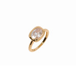 Gold ring with a cubic zirconia on a white background