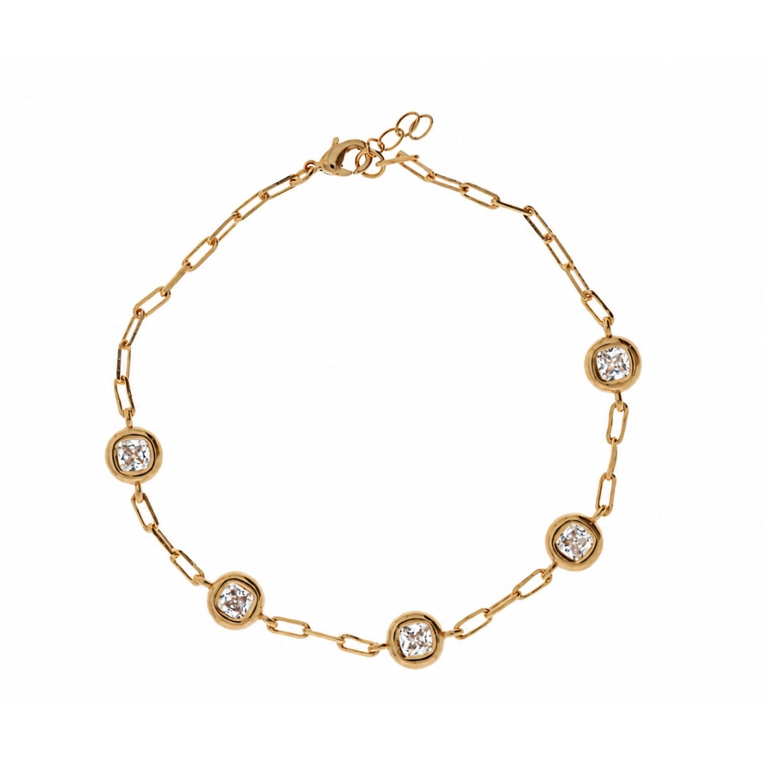 A gold chain bracelet with five evenly spaced round bezel-set clear gemstones on a white background.