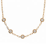 A yellow gold chain necklace featuring five evenly spaced round bezel-set diamond accents on a clean white background.