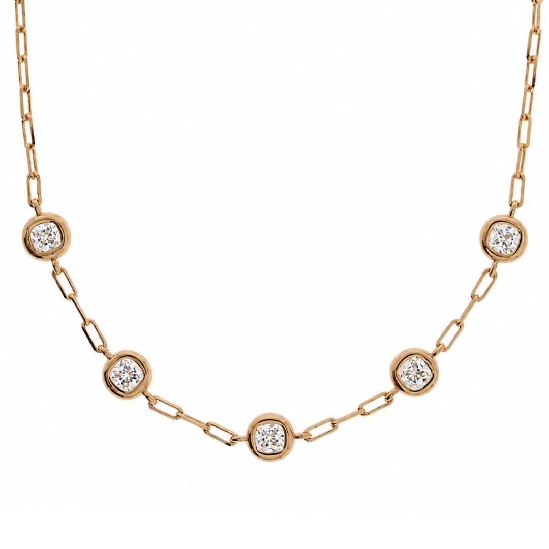 A yellow gold chain necklace featuring five evenly spaced round bezel-set diamond accents on a clean white background.