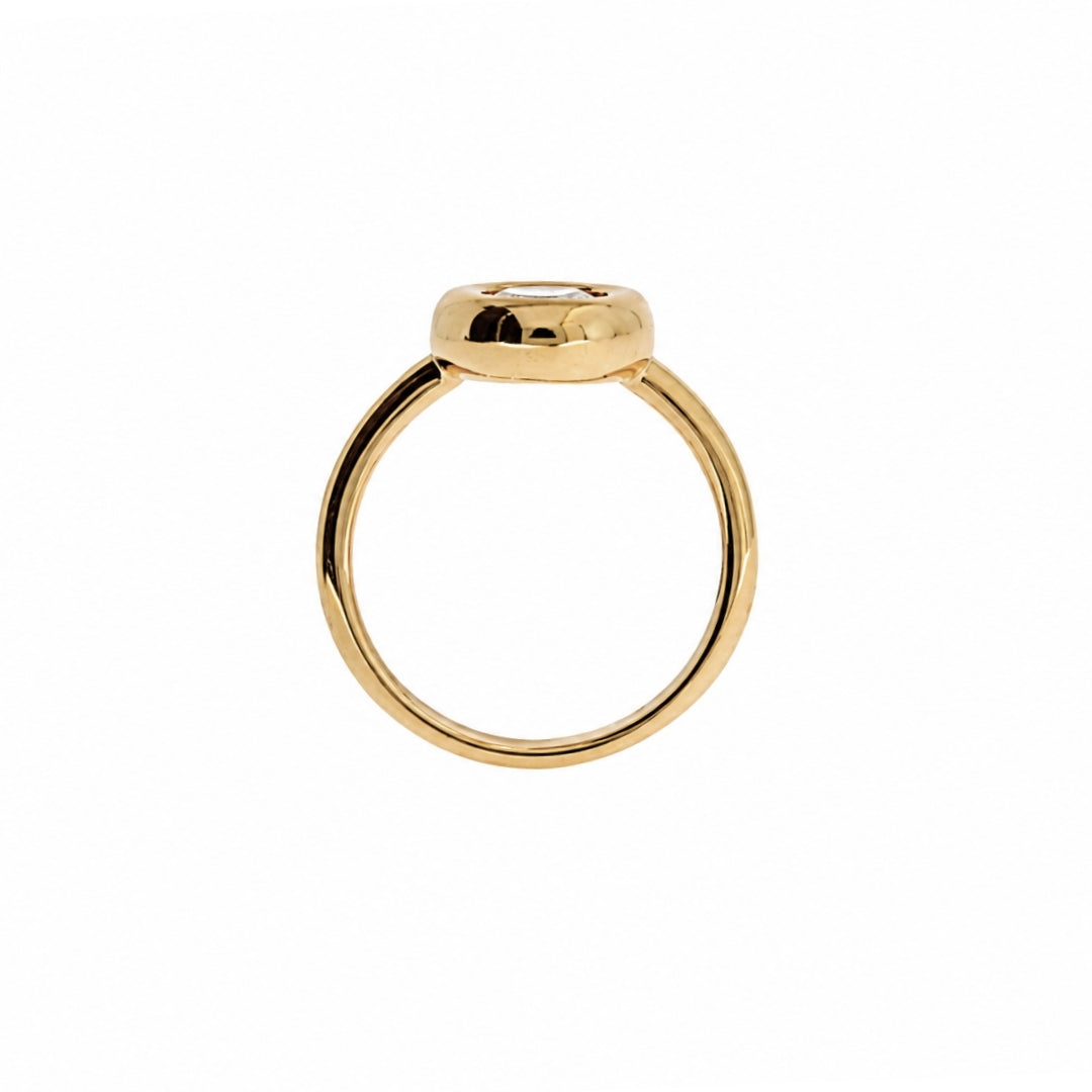 A gold ring with a thick, polished band and a flat, circular top, shown against a plain white background.