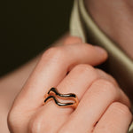 Model wearing the Sweet Peach gold plated wave ring, close up on the finger