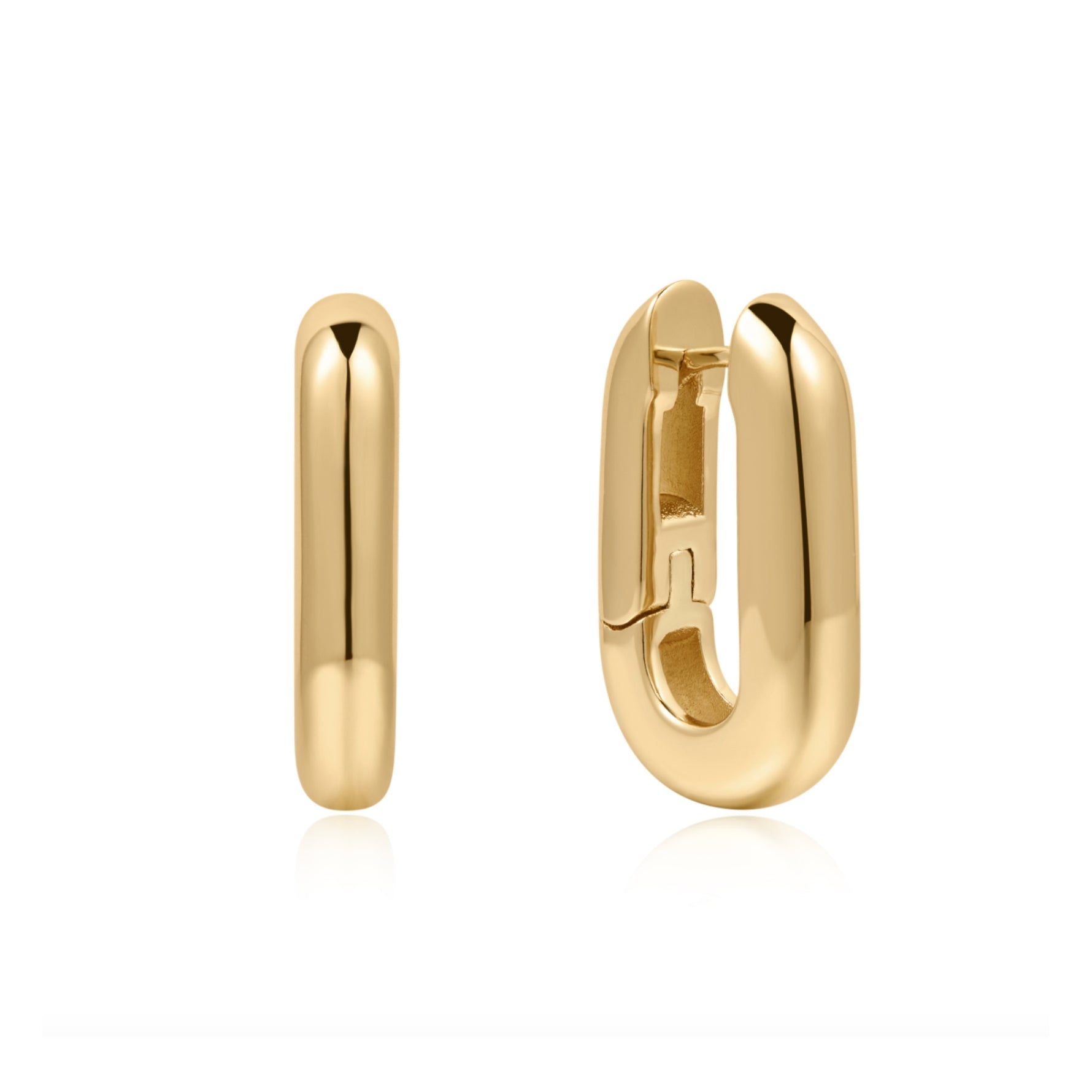 A pair of polished plated gold huggie hoop earrings, one shown from a side profile and the other from a front-three-quarter angle displaying the clasp mechanism, set against a clean white background with a soft reflection.