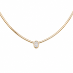 A delicate yellow gold snake chain necklace featuring a single bezel-set oval clear gemstone pendant, shown against a plain white background.