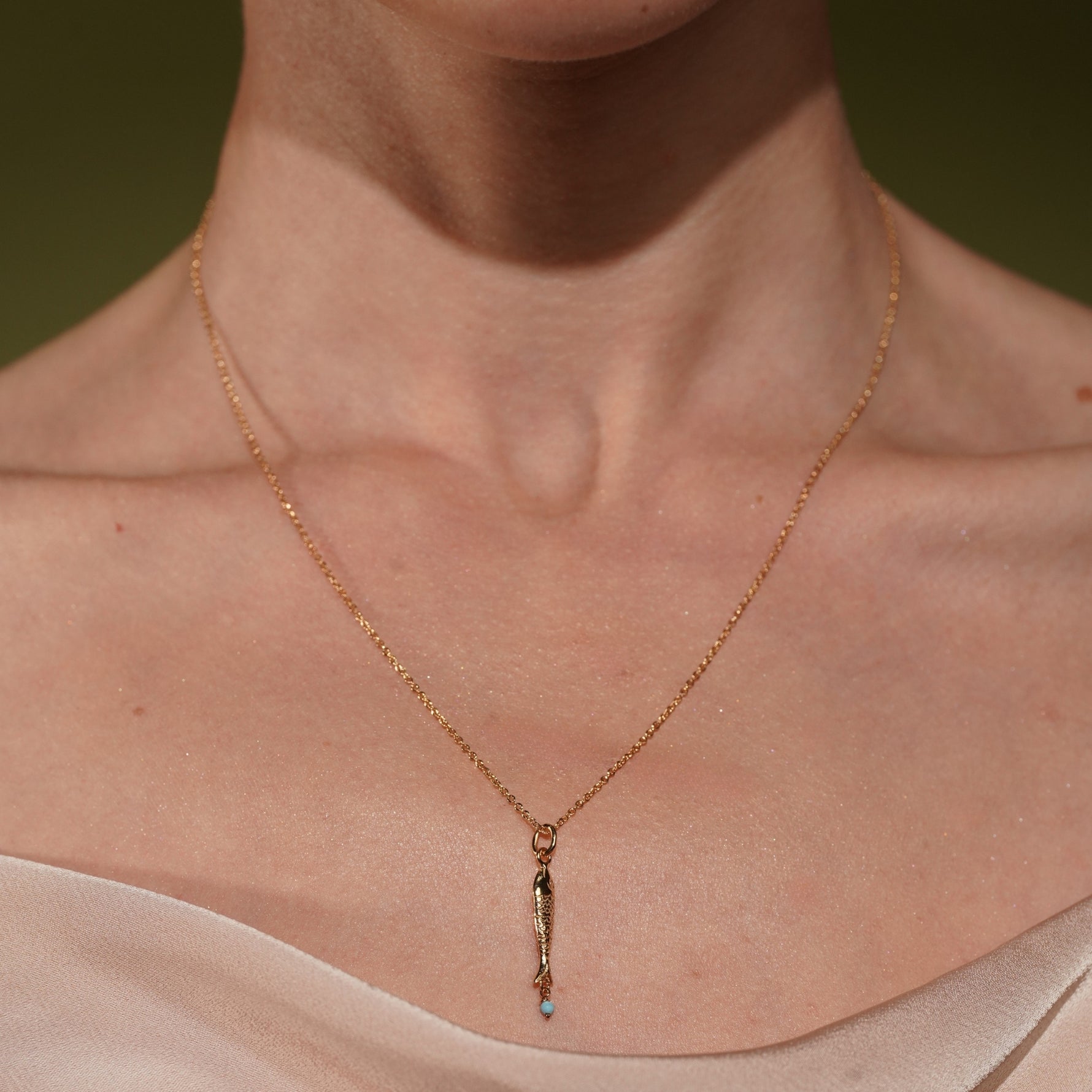 Model wearing Under the Sea 18K Gold Plated Fish Pendant Necklace with Turquoise Bead | Burren Jewellery
