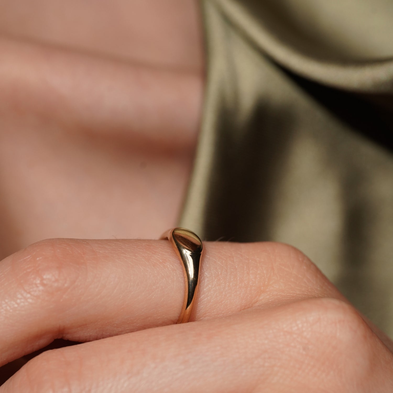 Model wearing the Soft Obsession gold plated signet ring, side profile showing the tapered band