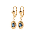 A pair of gold leverback dangle earrings with oval-cut blue gemstones in ornate gold settings, shown against a plain white background.