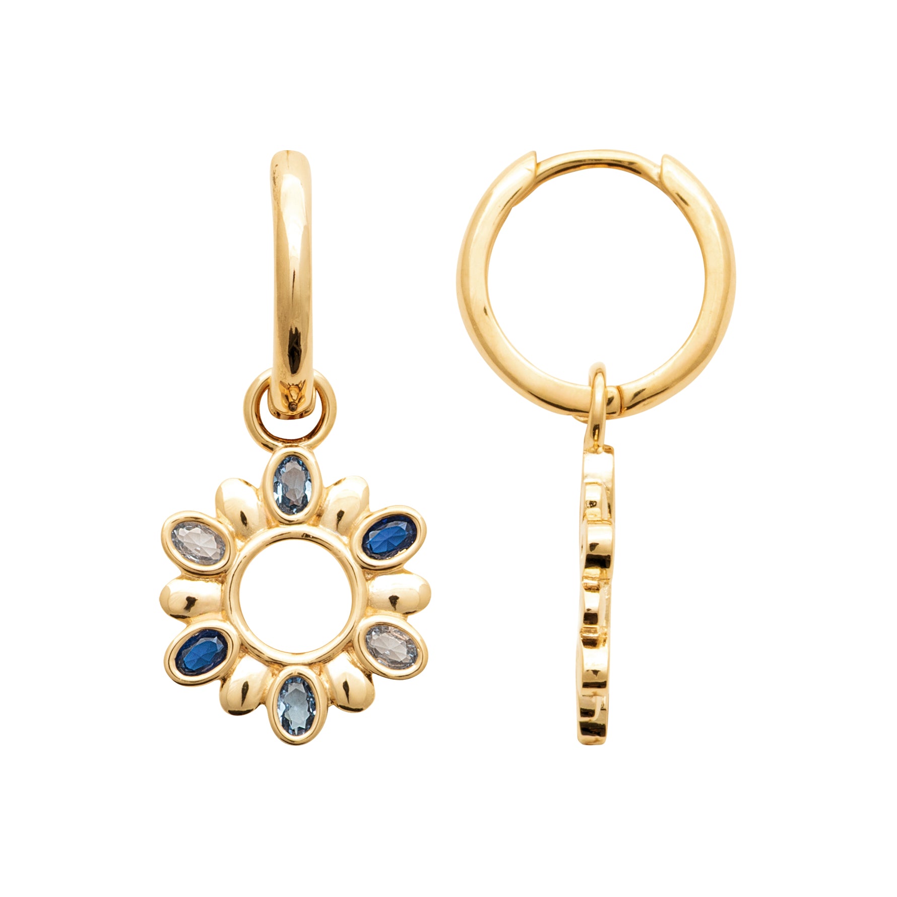 A pair of gold huggie hoop earrings with a dangling flower charm. One earring is shown from the front, featuring a gold flower head with blue and light blue gemstone accents, and the other is shown from the side to display the textured vertical bar on the hoop.