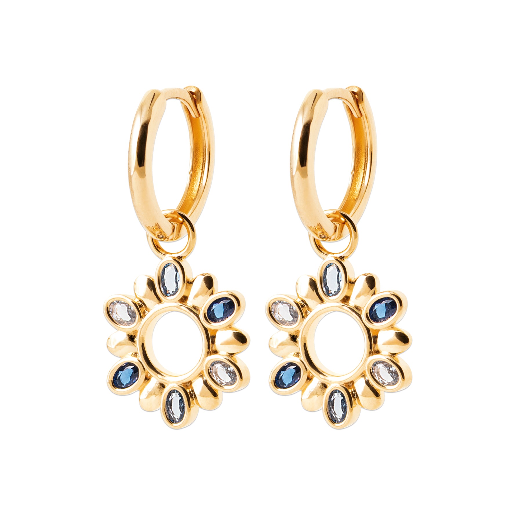 A pair of gold huggie hoop earrings with dangling sunflower charms, embellished with small blue and clear rhinestones, shown on a plain white background.
