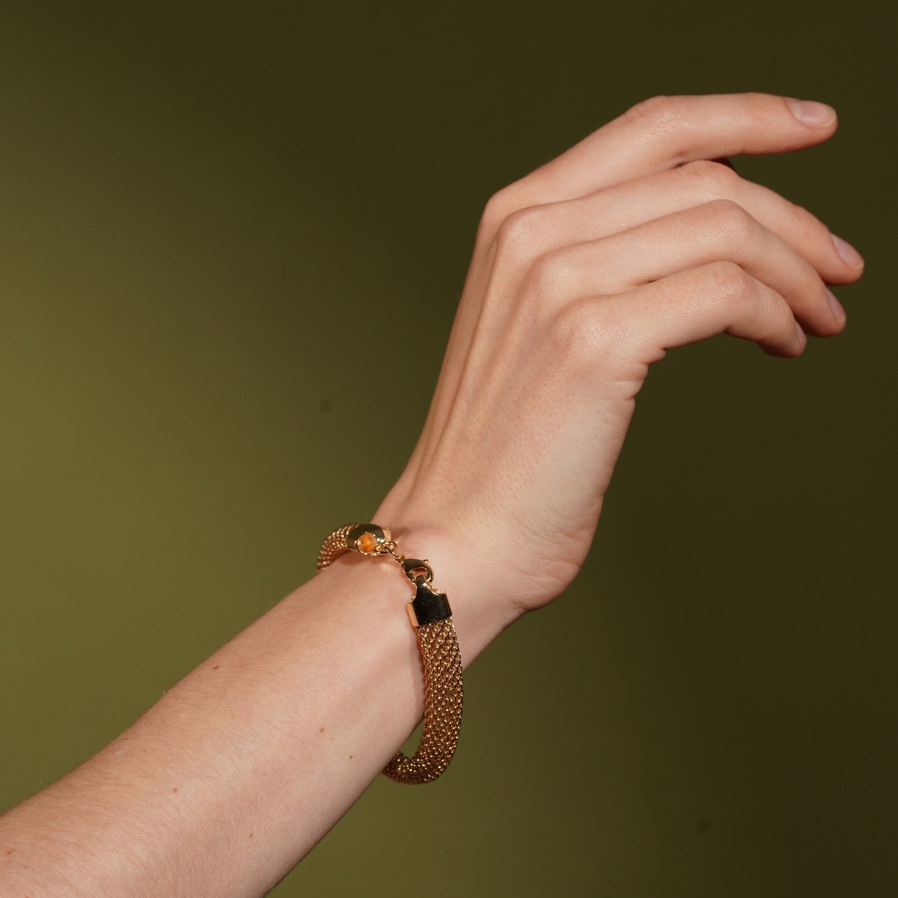 Model wearing the Long Way Home gold plated woven cord bracelet, close up on the clasp