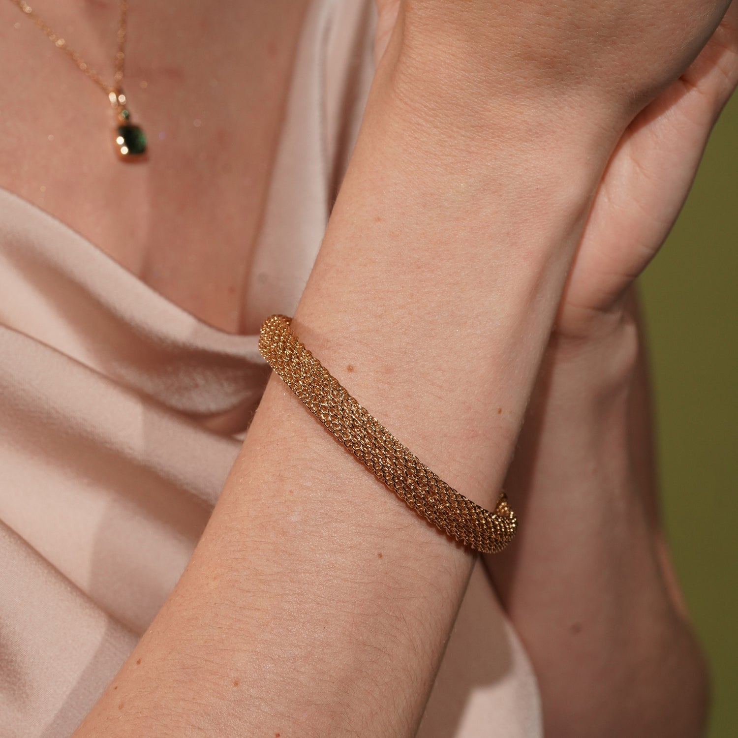 Model wearing the Long Way Home gold plated woven cord bracelet, close up on the rounded texture