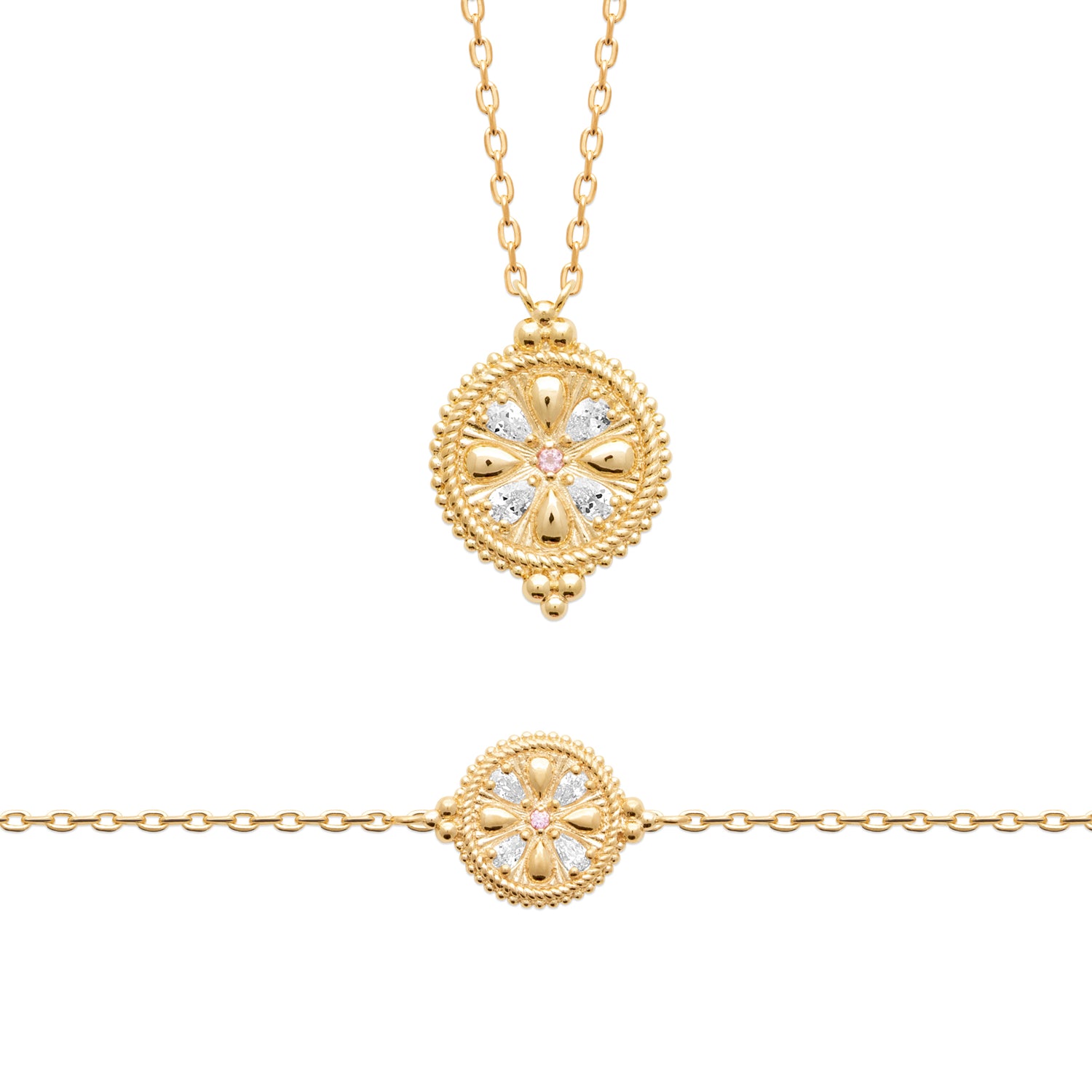 Gold jewelry set featuring a delicate chain necklace and a matching bracelet, both with a circular medallion pendant decorated with clear gemstones in a floral pattern.