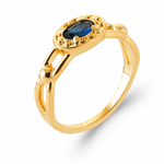 A gold ring with a marquise-cut blue gemstone in an oval setting, surrounded by small gold accents, shown on a clean white background.