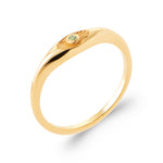 Gold ring with a green gemstone on a white background