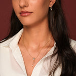 A close-up of a model wearing Better Off Earrings and Necklace in 18K Gold Plating Featuring Genuine Freshwater Pearl Drops and Mixed-Cut Clear Cubic Zirconia with Delicate Double Chain Detail | Burren Jewellery